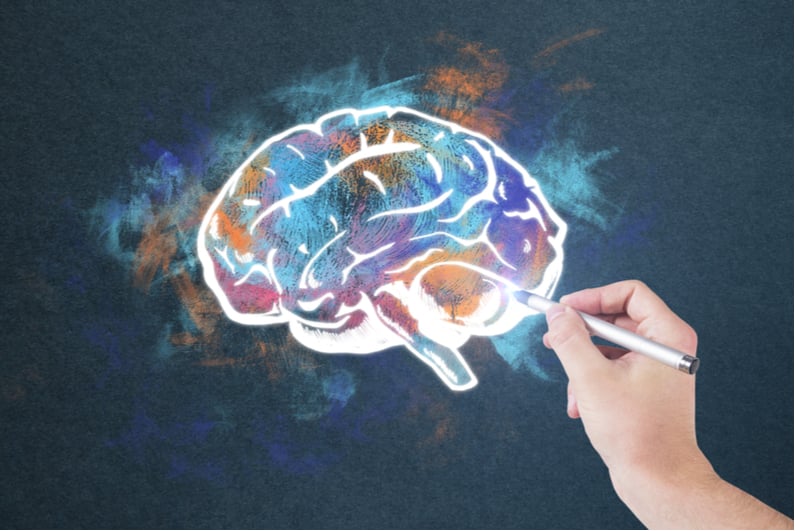 Hand doing colorful drawing of brain