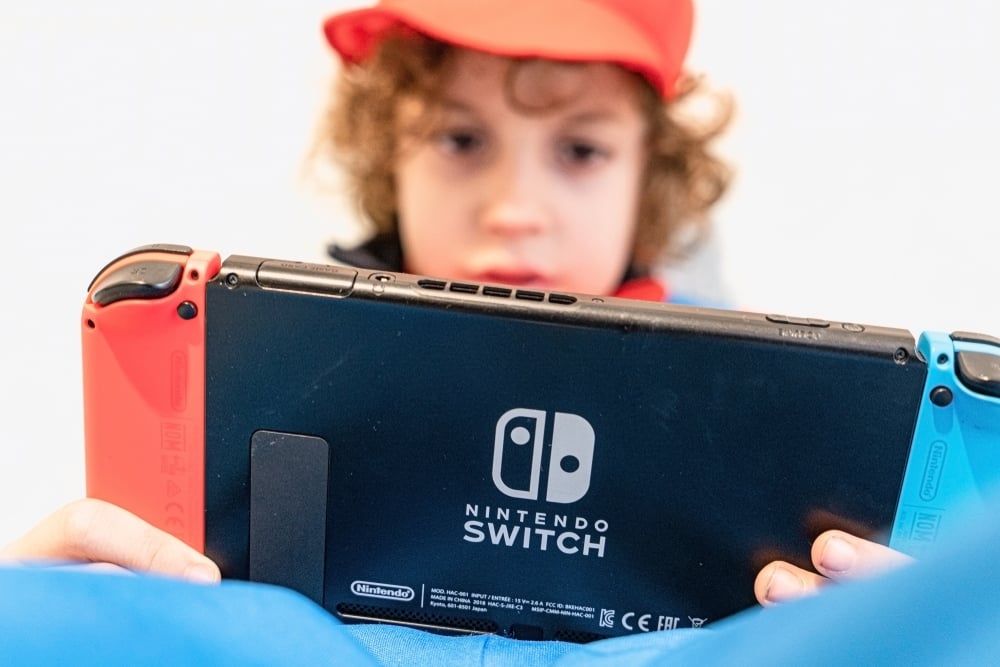 boy playing on nintendo switch