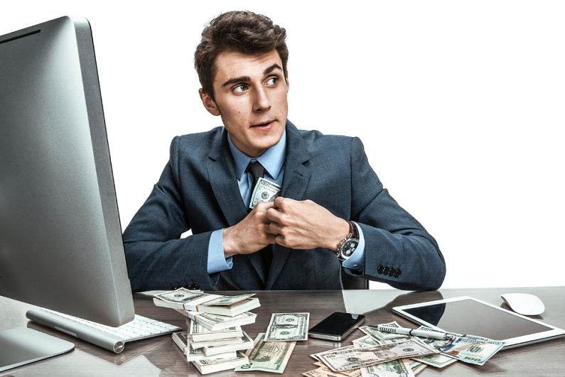 Suited man sitting at a desk and stealing money.