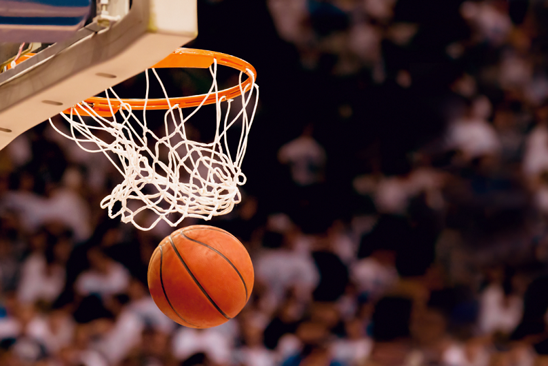 Basketball falling through a net.