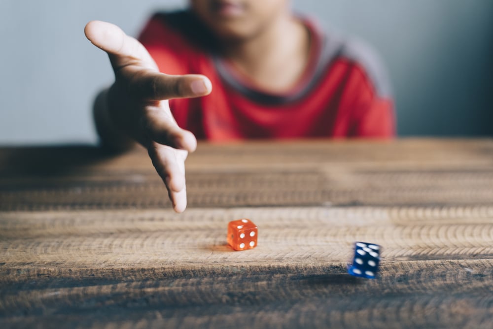 boy rolling dice