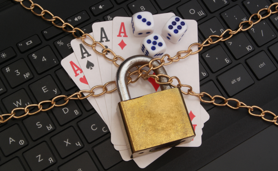 locked dice, playing cards and computer keyboard