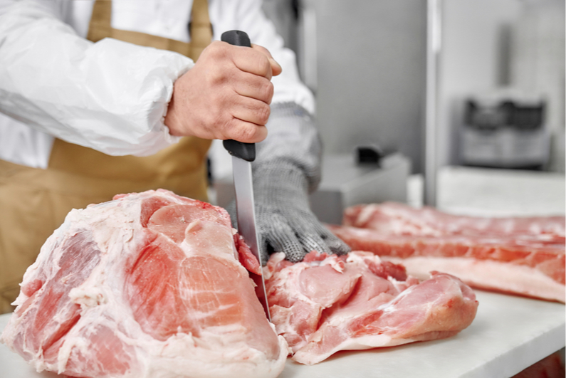 Butcher cutting meat