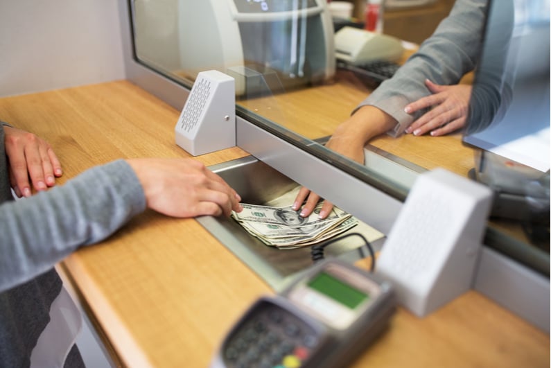 Person withdrawing money at a bank