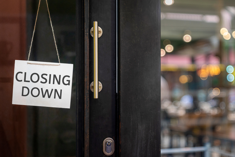 Closing down sign hanging on a shop door