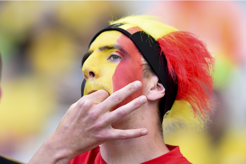 Belgian soccer fan whistling through fingers